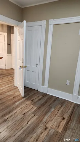 a view of a room with wooden floor and windows