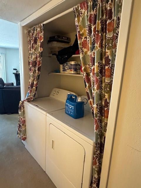 4448 Chaha Road, Unit 205 Garland, TX 75043 - Photo 5 of 5 Dedicated laundry area featuring a washer and dryer unit, built-in shelving, and a privacy curtain