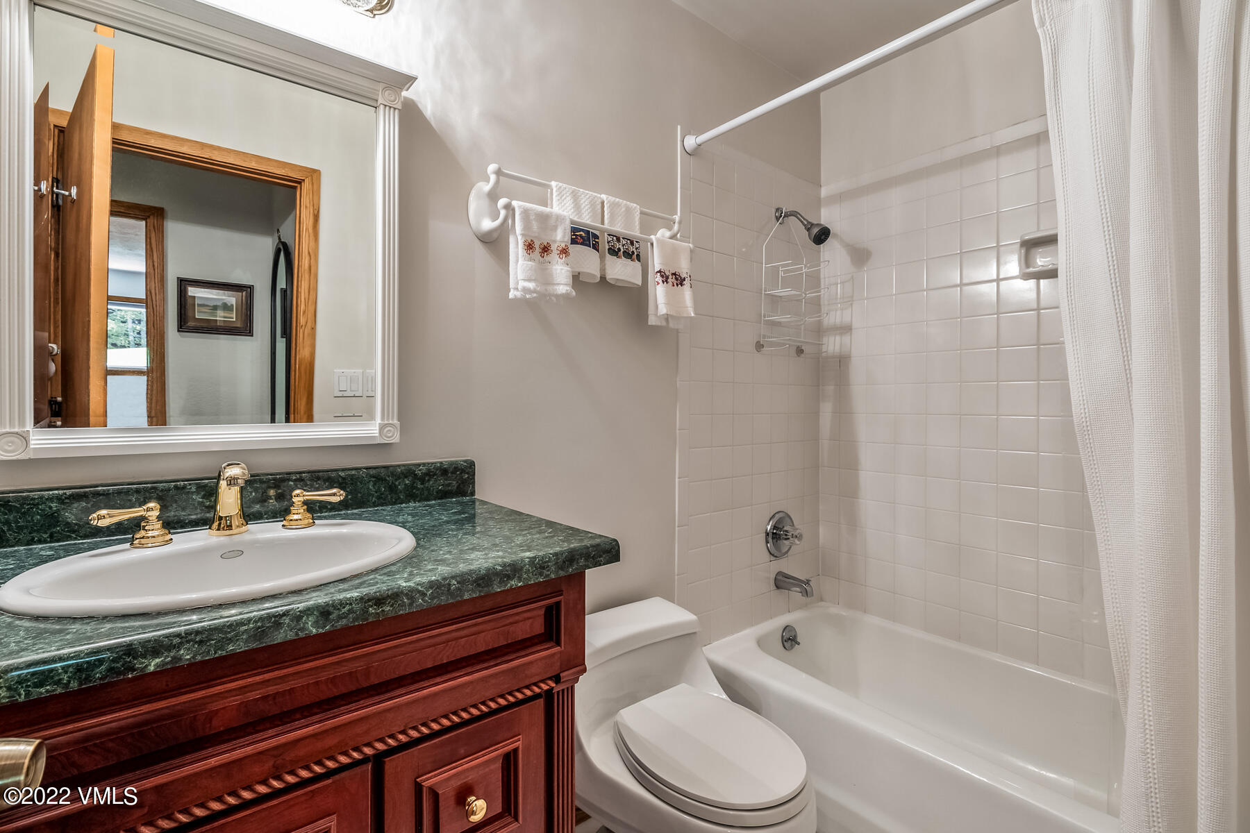 8 Deer Boulevard Eagle-Vail, CO 81620 - Photo 22 of 34 a bathroom with a granite countertop sink a toilet and shower