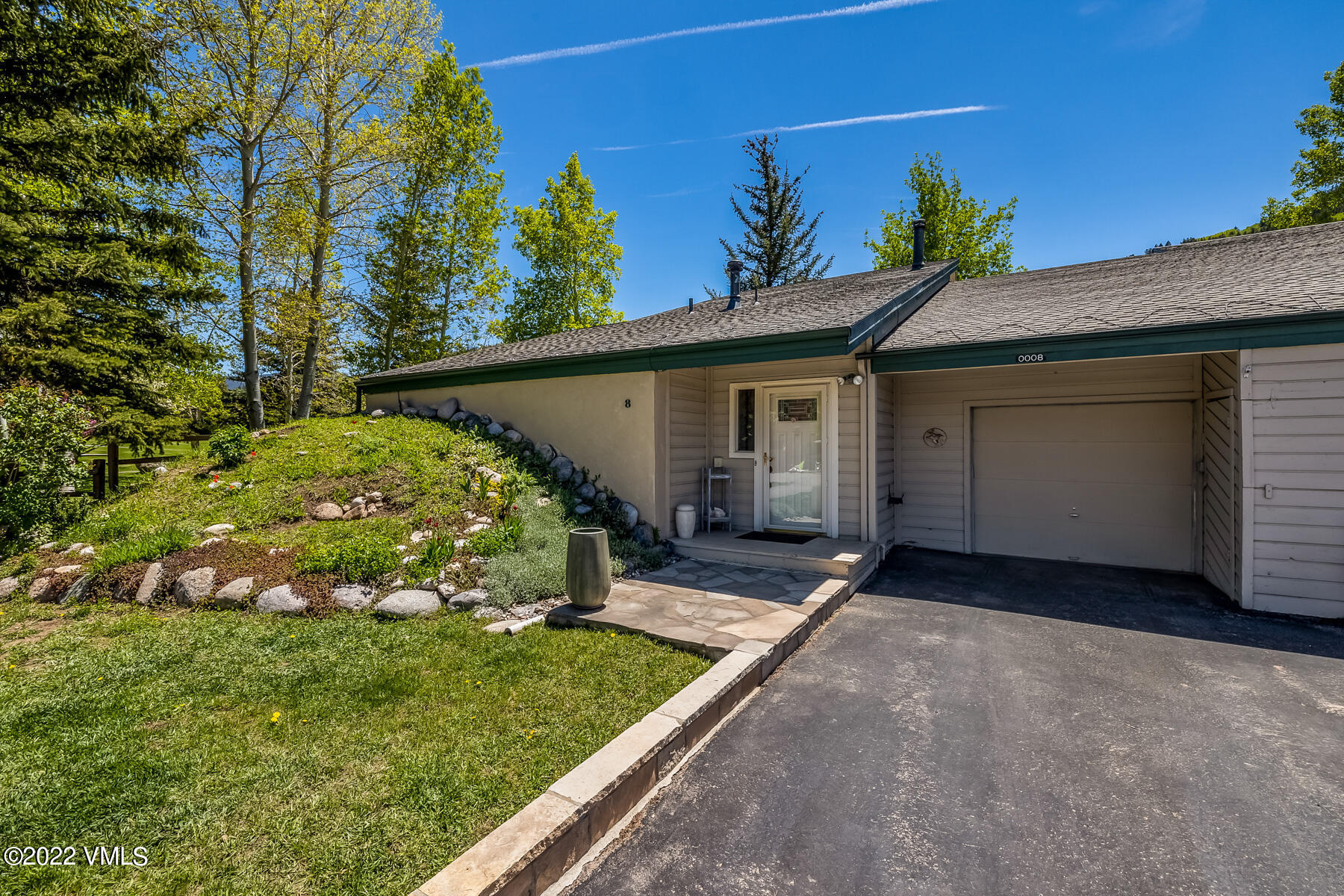 8 Deer Boulevard Eagle-Vail, CO 81620 - Photo 23 of 34 a view of a house with a small yard and potted plants