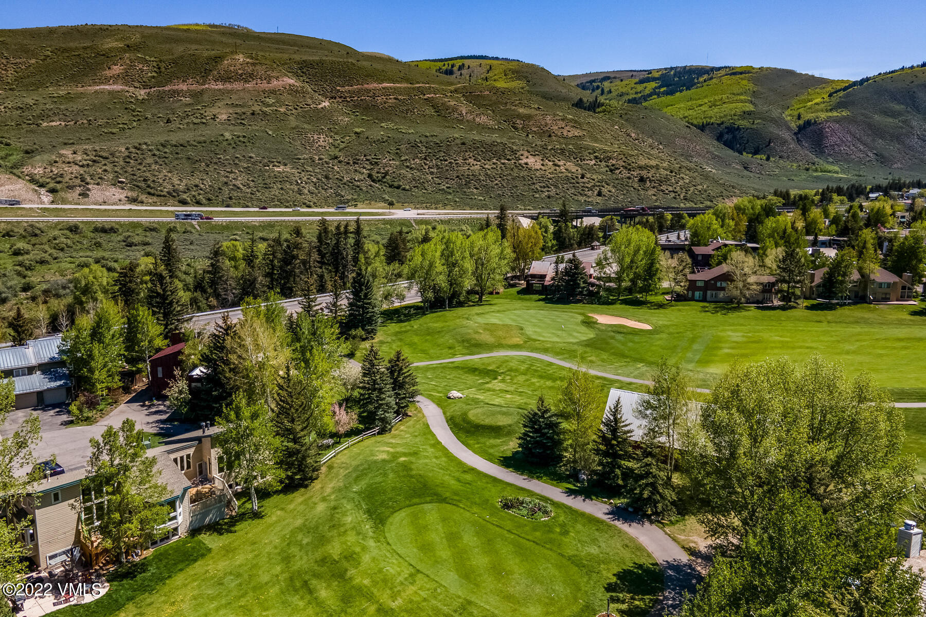 8 Deer Boulevard Eagle-Vail, CO 81620 - Photo 27 of 34 a view of a swimming pool with a garden