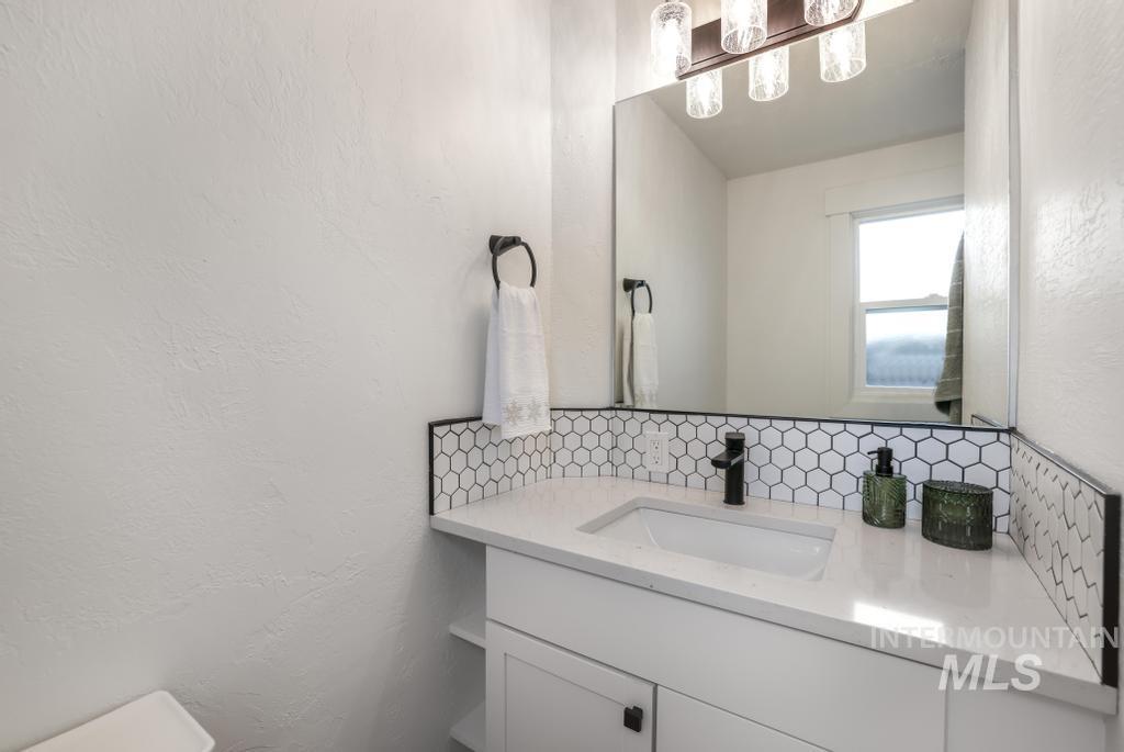 344 Fillmore Street Twin Falls, ID 83301 - Photo 18 of 42 Bathroom with a textured wall, vanity, and decorative backsplash