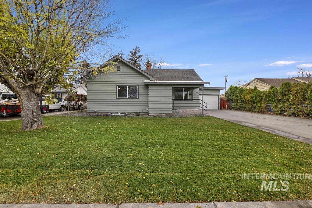 344 Fillmore Street Twin Falls, ID 83301 - Photo 34 of 42 View of front of house with a front lawn, a chimney, driveway, and a garage