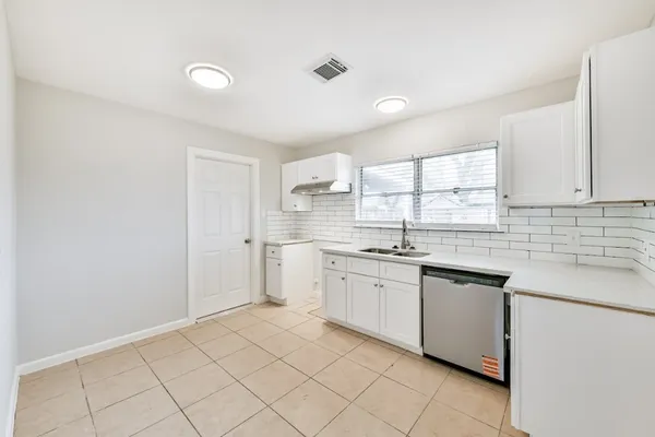 a kitchen with a sink cabinets and window