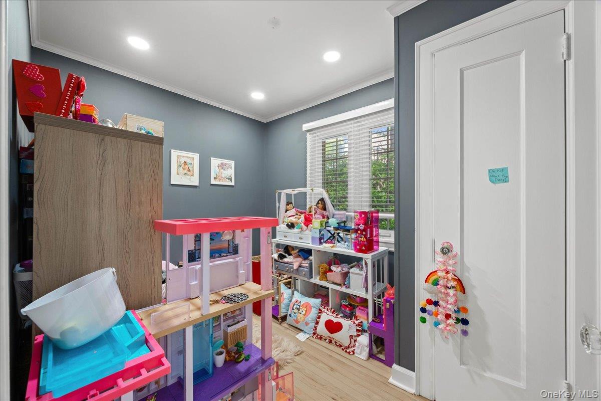 311 Lyncroft Road New Rochelle, NY 10804 - Photo 18 of 39 a room with furniture a baby crib and a couch