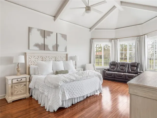 a bedroom with a large bed and a couch