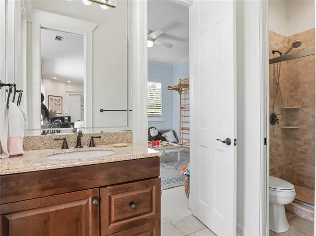 a bathroom with a granite countertop sink toilet and shower