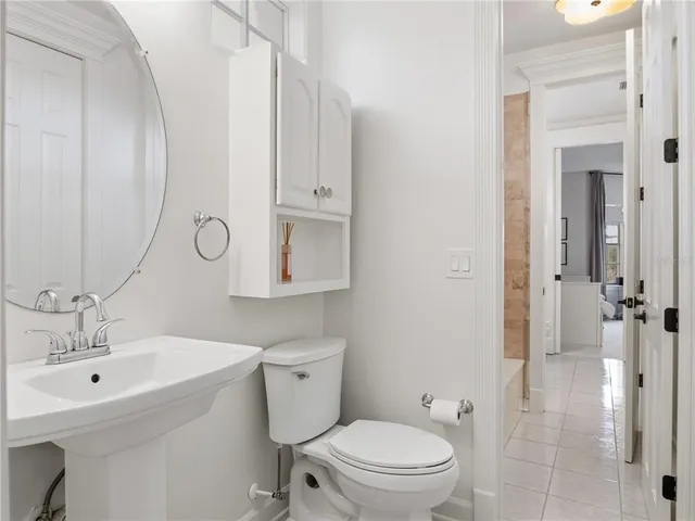 a bathroom with a toilet sink a shower and a mirror