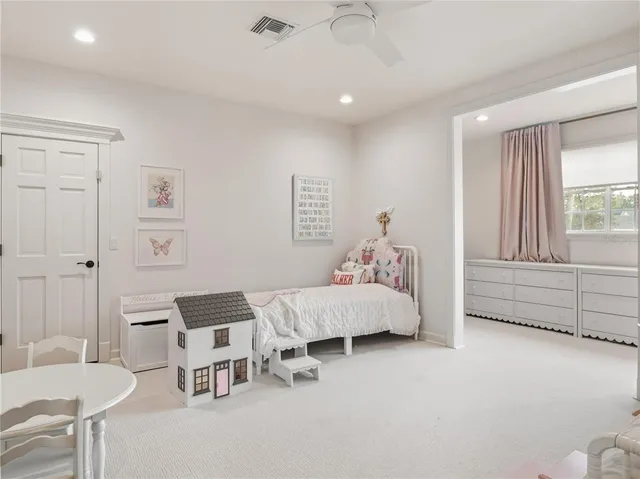 a bed room with a bed and a chair