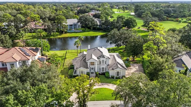 an aerial view of a house with a yard basket ball court and outdoor seating