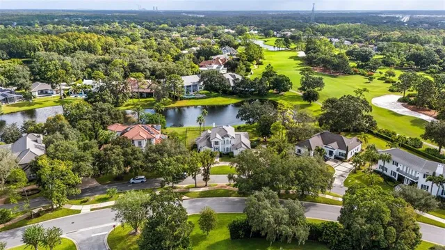 an aerial view of residential houses with outdoor space and swimming pool