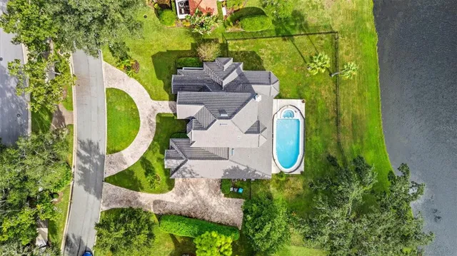 an aerial view of a house with a swimming pool