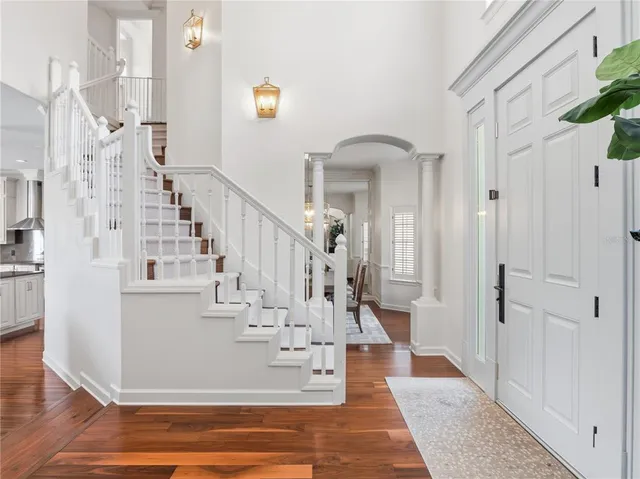 a view of entryway and hall with wooden floor