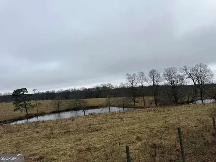 a view of swimming pool with a table under an umbrella