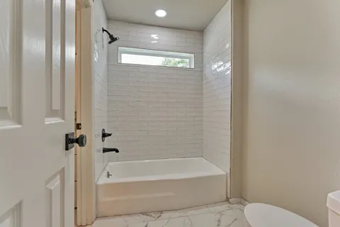 a bathroom with a bathtub and a shower