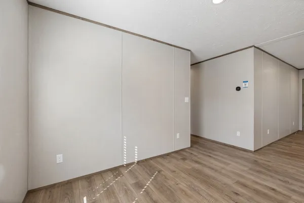a kitchen with stainless steel appliances granite countertop a stove a sink a refrigerator white cabinets and a refrigerator
