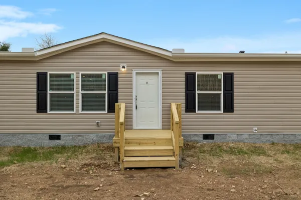 a view of kitchen with stainless steel appliances kitchen island granite countertop a refrigerator and a stove top oven