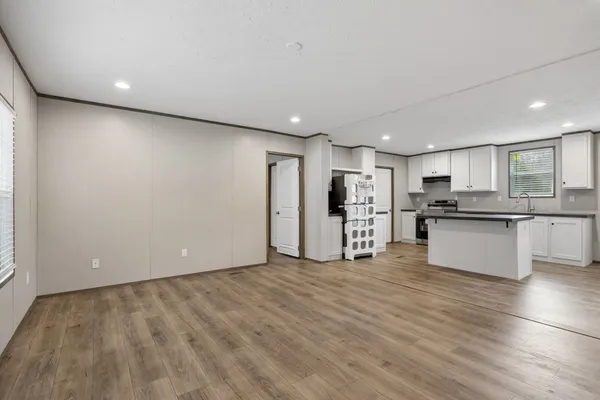 a view of kitchen with wooden floor and electronic appliances
