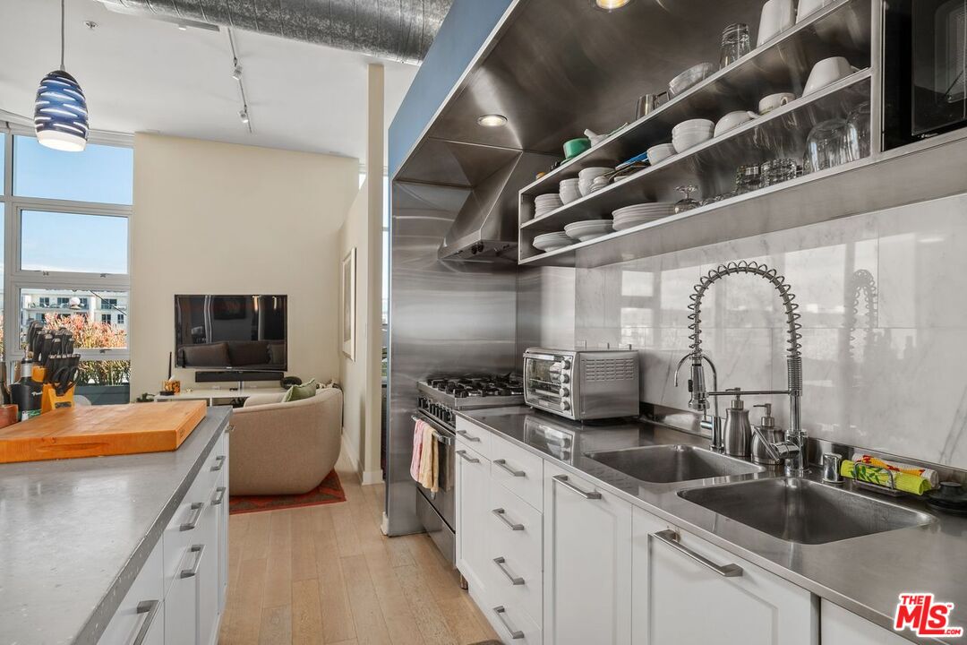 4080 Glencoe Avenue, Unit 420 Marina del Rey, CA 90292 - Photo 11 of 40 a kitchen with stainless steel appliances granite countertop a sink and a stove