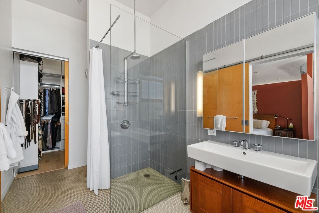 4080 Glencoe Avenue, Unit 420 Marina del Rey, CA 90292 - Photo 17 of 40 a bathroom with a sink and a mirror with bathtub