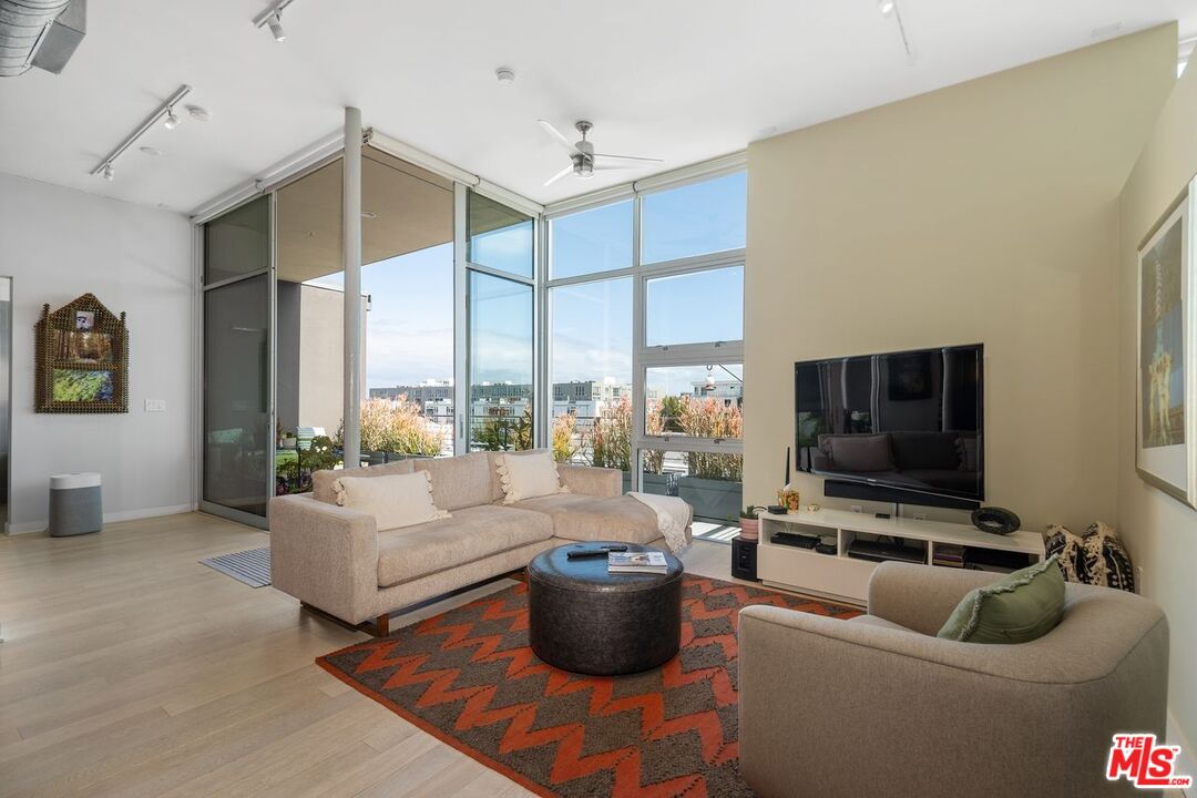 4080 Glencoe Avenue, Unit 420 Marina del Rey, CA 90292 - Photo 2 of 40 a living room with furniture and a flat screen tv