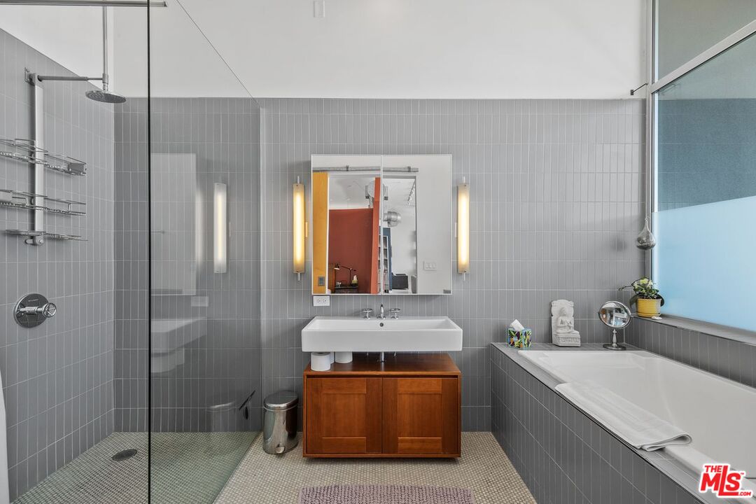 4080 Glencoe Avenue, Unit 420 Marina del Rey, CA 90292 - Photo 21 of 40 a bathroom with a tub a sink and mirrors