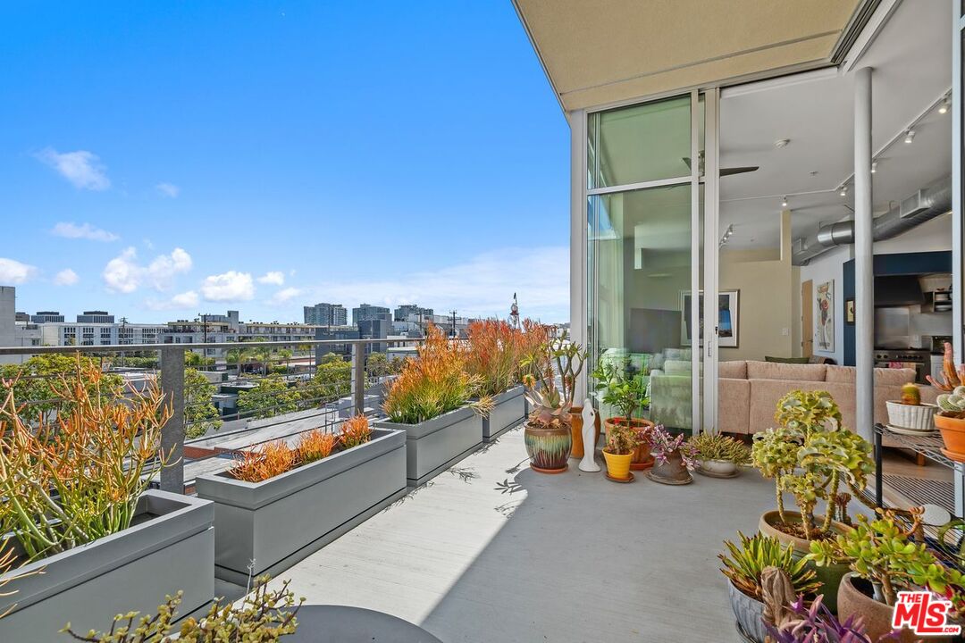 4080 Glencoe Avenue, Unit 420 Marina del Rey, CA 90292 - Photo 26 of 40 a city view from a balcony with dining table and chairs