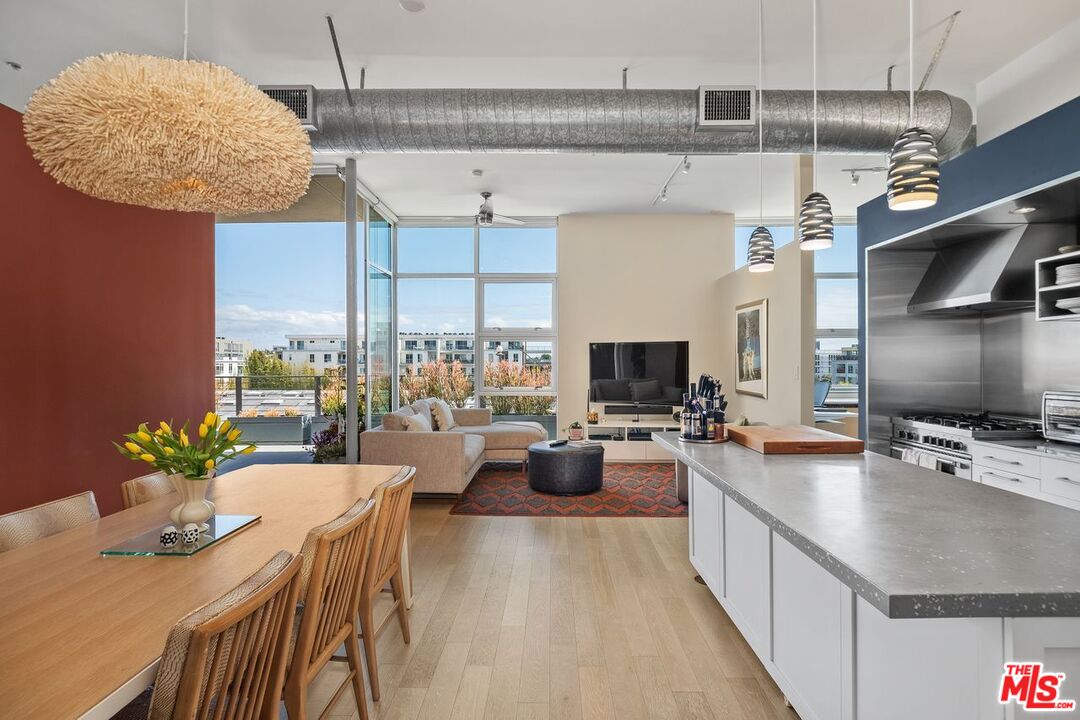 4080 Glencoe Avenue, Unit 420 Marina del Rey, CA 90292 - Photo 3 of 40 a large kitchen with a table chairs and a potted plant