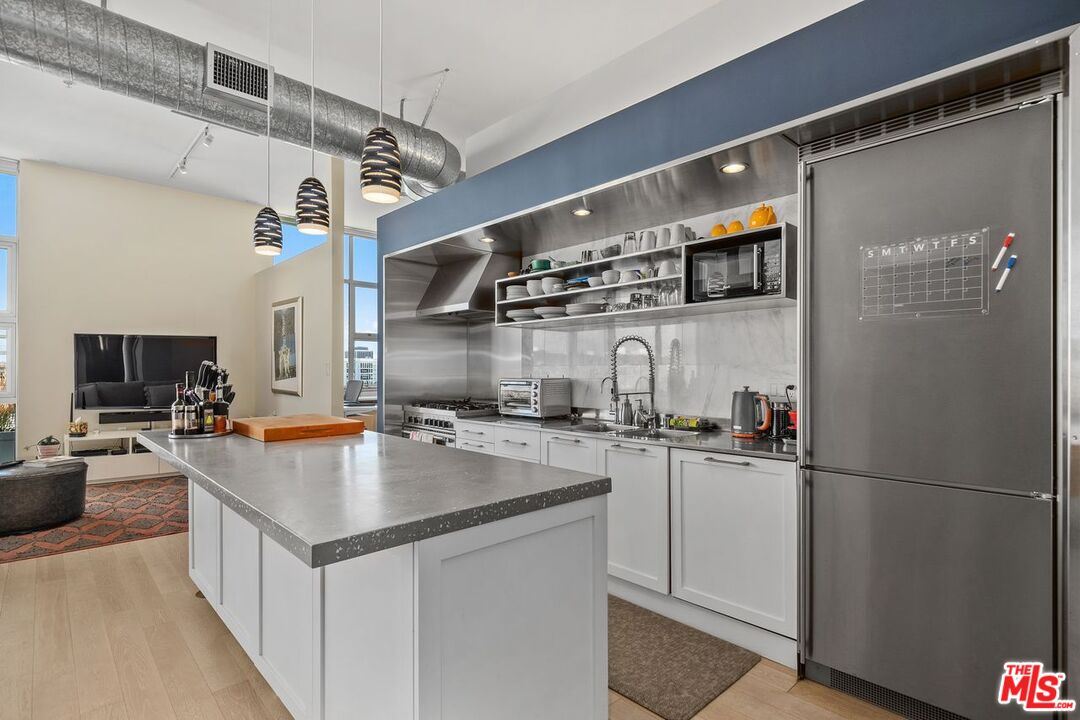 4080 Glencoe Avenue, Unit 420 Marina del Rey, CA 90292 - Photo 9 of 40 a kitchen with a sink appliances and cabinets