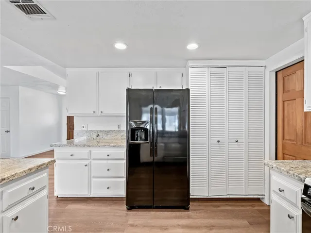 a kitchen with a refrigerator and a stove top oven