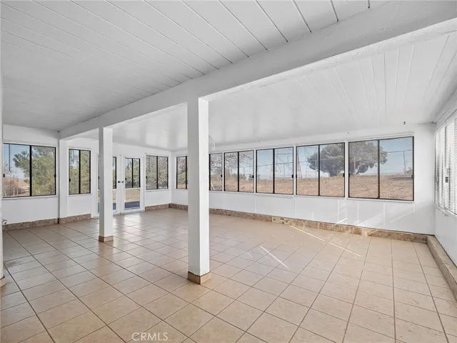a view of empty room with wooden floor and fireplace