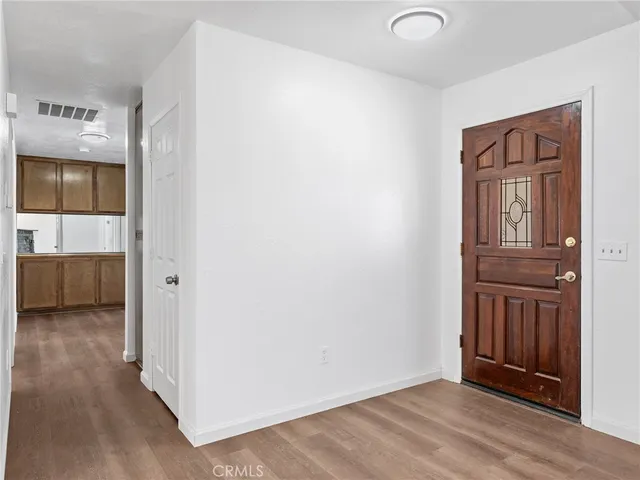a view of front door with wooden floor