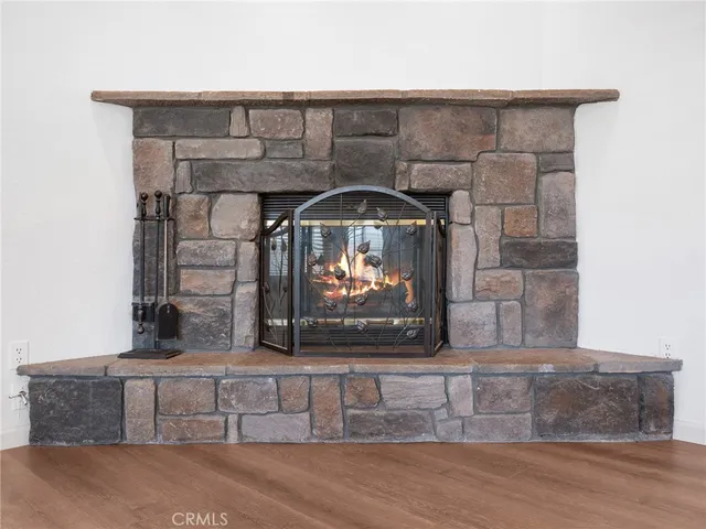 a view of fireplace and wooden floor