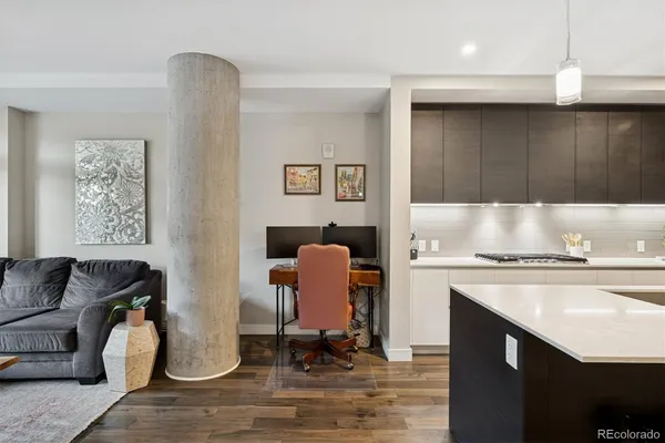 a kitchen with a refrigerator and a stove top oven