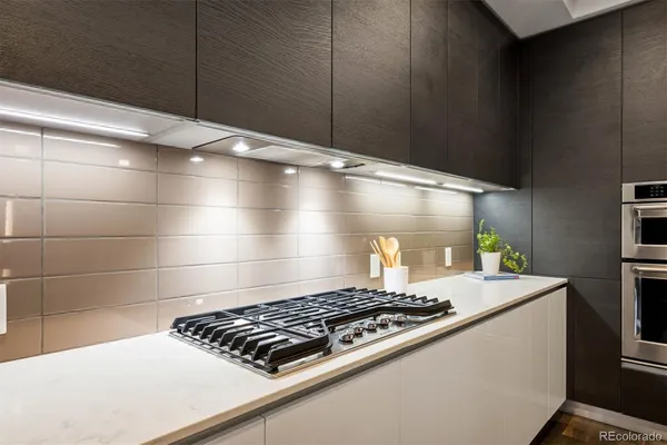 a stove top oven sitting inside of a kitchen