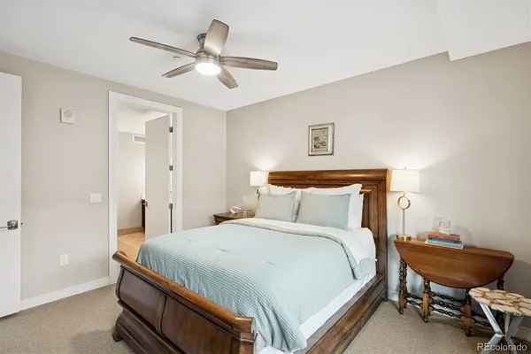 a bedroom with a bed and a ceiling fan