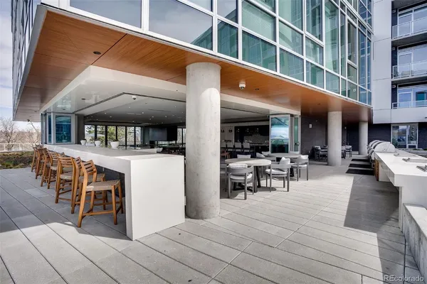a view of a patio with dining table and chairs