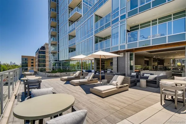 a view of a patio with a table and chairs under an umbrella