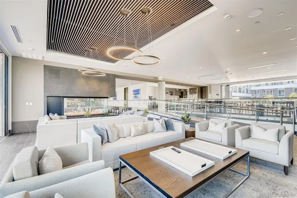 a living room with furniture and view of kitchen