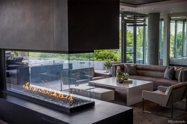 a living room with furniture and a floor to ceiling window