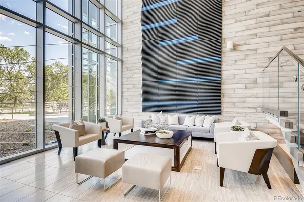 a dining room with furniture and floor to ceiling windows