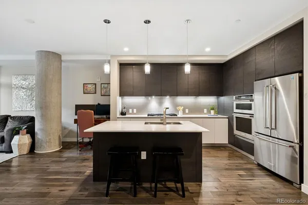 a kitchen with kitchen island stainless steel appliances a sink and counter space