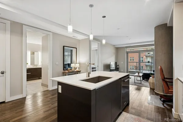 a kitchen with counter top space and wooden floor