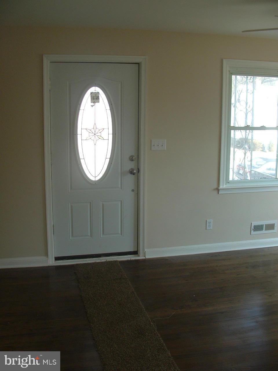 1819 Wendover Road Baltimore, MD 21234 - Photo 17 of 30 an empty room with wooden floor and windows