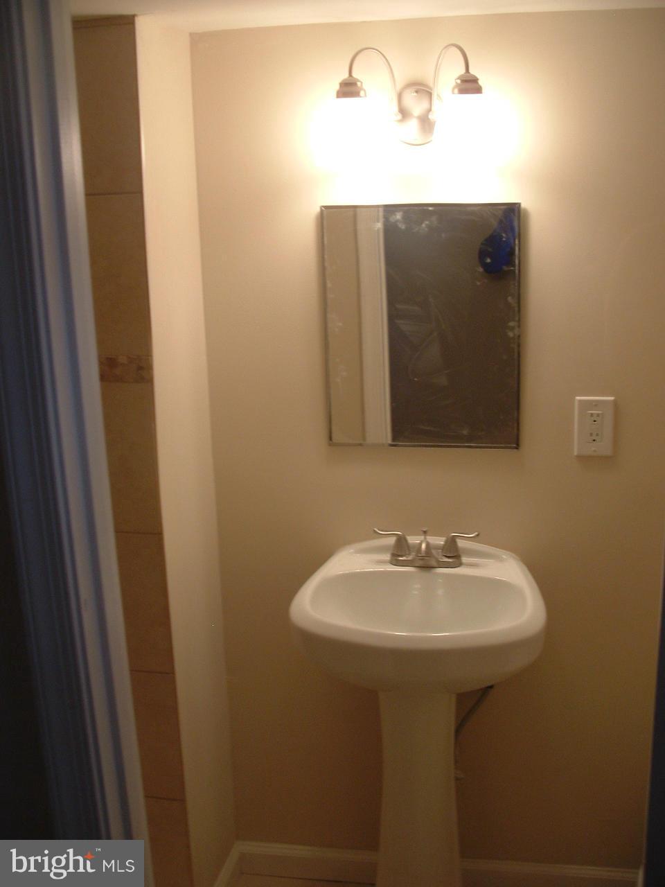 1819 Wendover Road Baltimore, MD 21234 - Photo 23 of 30 a bathroom with a sink and mirror