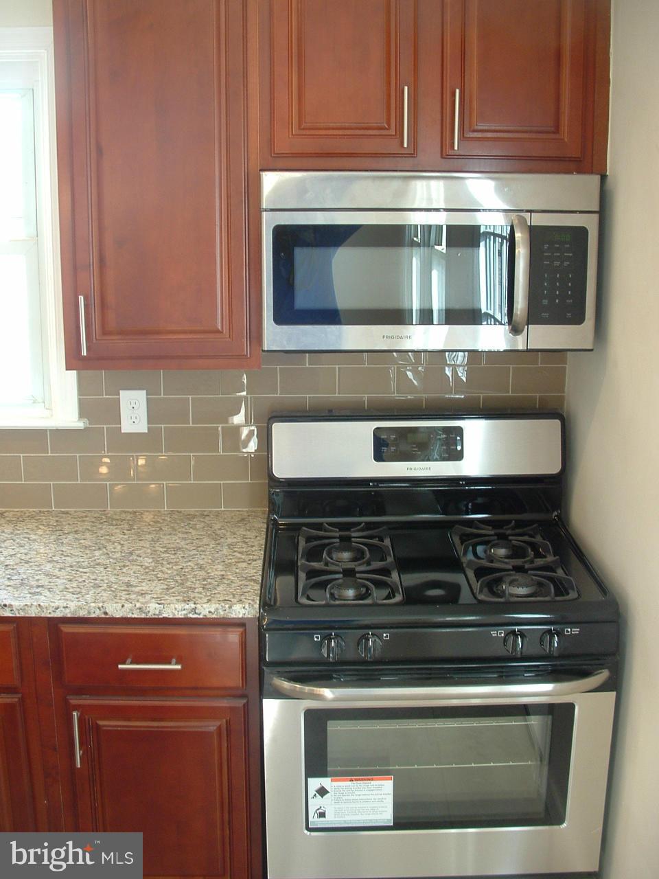 1819 Wendover Road Baltimore, MD 21234 - Photo 7 of 30 a stove top oven sitting inside of a kitchen