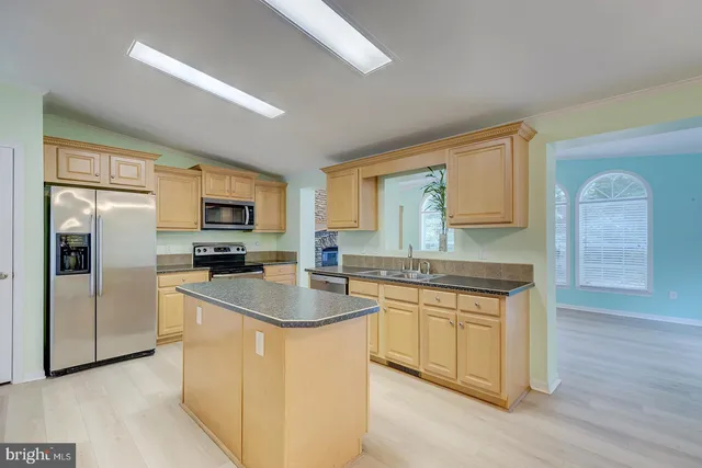 a kitchen with stainless steel appliances granite countertop a sink and cabinets