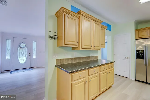 a kitchen with stainless steel appliances granite countertop a sink a stove and cabinets