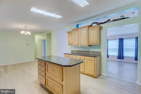 a kitchen with granite countertop a sink stainless steel appliances and cabinets