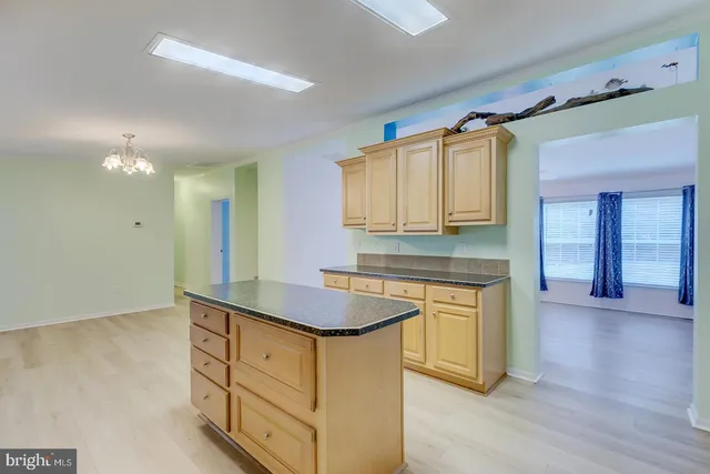 a kitchen with granite countertop a sink stainless steel appliances and cabinets
